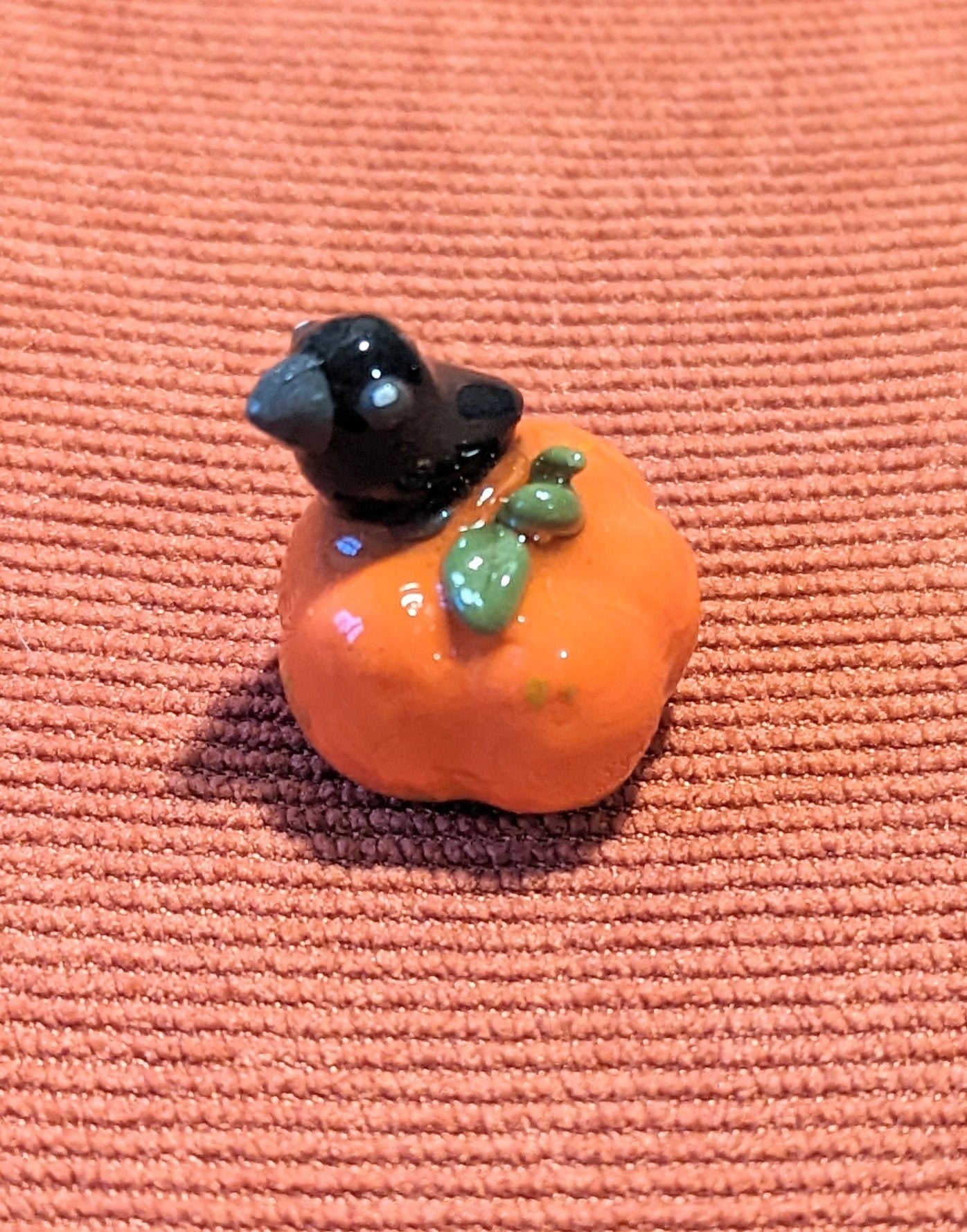 Figurine corbeau sur sa citrouille
